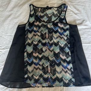 Geometric sleeveless sheer blouse.